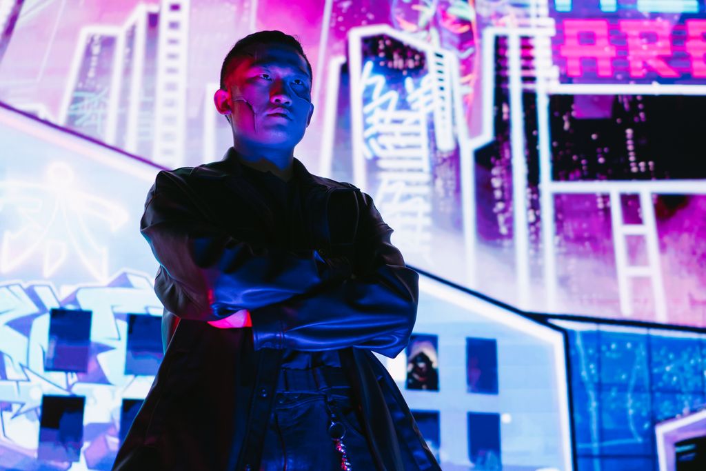 A striking portrait of a man in cyberpunk fashion, illuminated by vibrant neon lights.